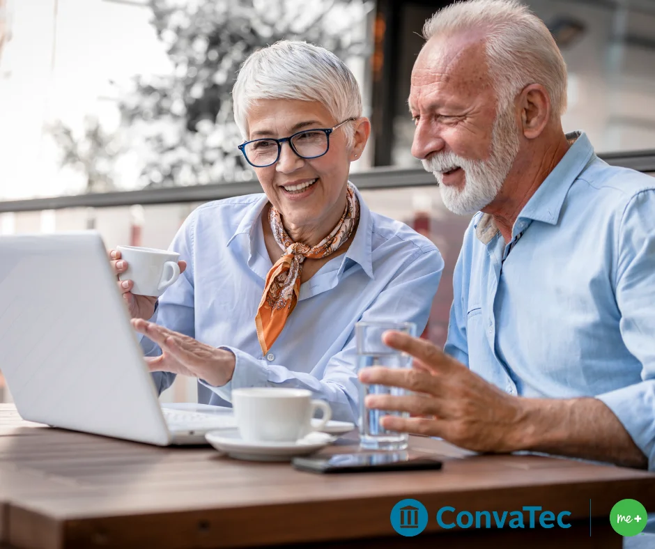 a man and a woman looking at a laptop
