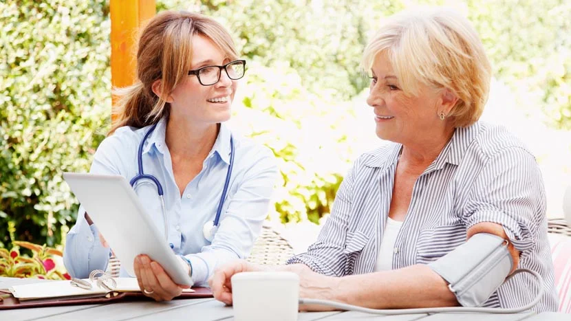 two women looking at a tablet