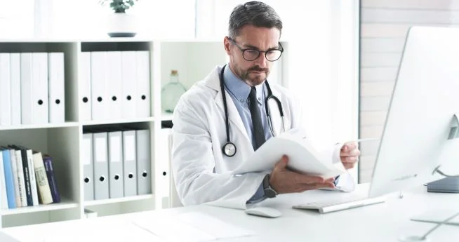 a doctor looking at a tablet